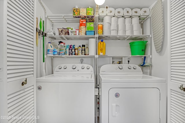 laundry room featuring washing machine and clothes dryer