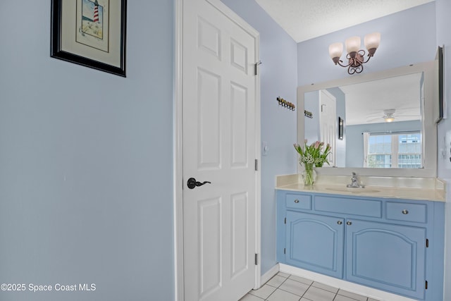 bathroom featuring a textured ceiling, vanity, tile patterned floors, and ceiling fan