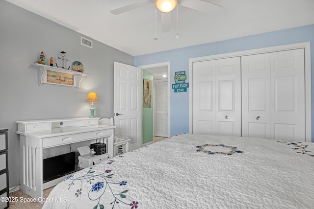 bedroom featuring a closet, ceiling fan, and light colored carpet