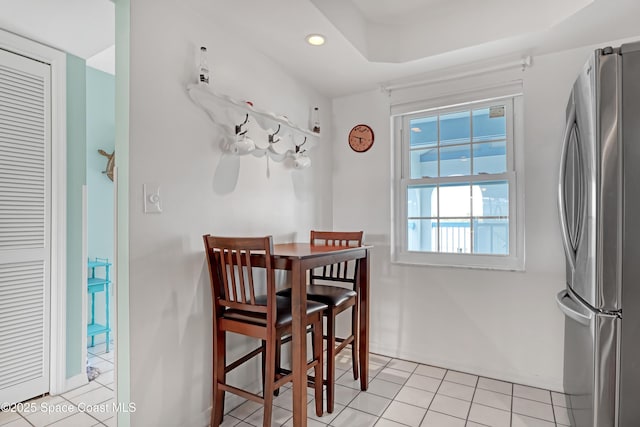 dining area with light tile patterned flooring