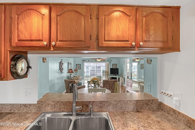 kitchen featuring ceiling fan and sink