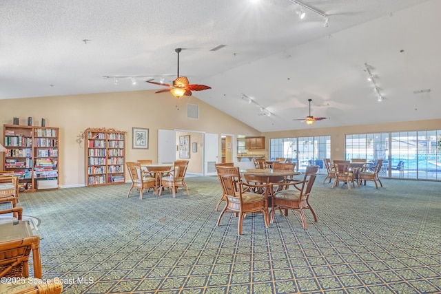 carpeted dining area featuring ceiling fan and lofted ceiling