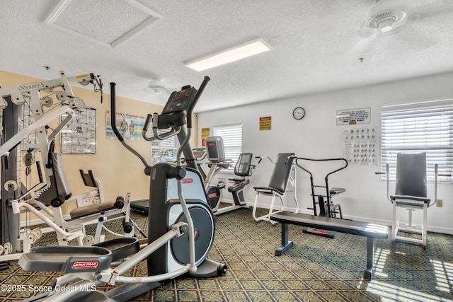 workout room with plenty of natural light and a textured ceiling