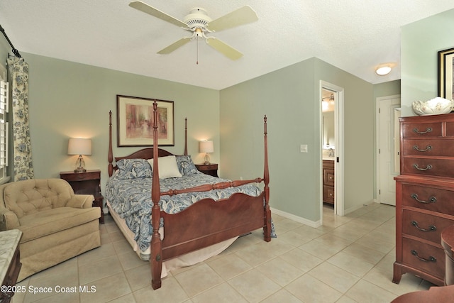 tiled bedroom with connected bathroom, ceiling fan, and a textured ceiling