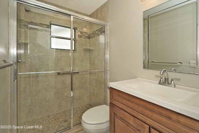 bathroom featuring vanity, toilet, and an enclosed shower