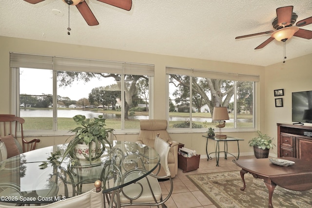 sunroom / solarium with a water view