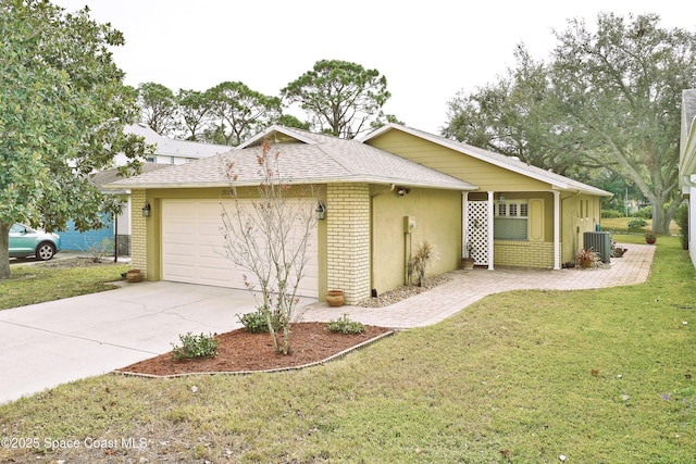 view of side of home featuring a lawn, central AC unit, and a garage