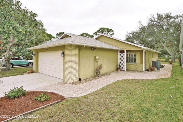 view of side of home featuring a garage, a yard, and central AC