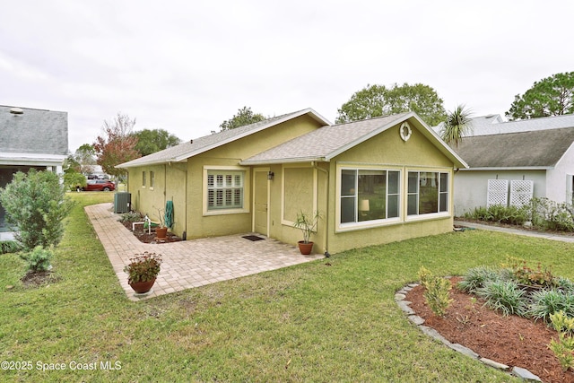 back of property featuring a lawn and a patio area