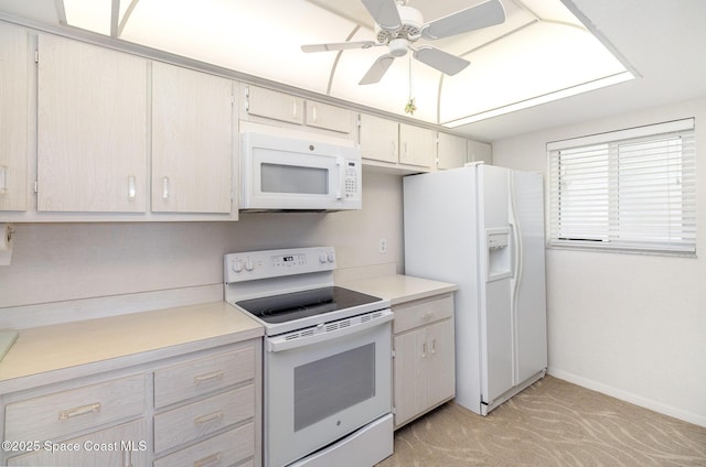 kitchen with white appliances, baseboards, light countertops, and a ceiling fan