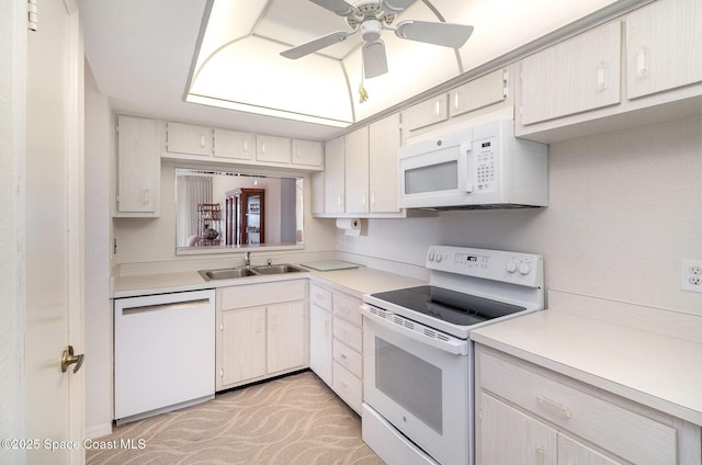 kitchen with light countertops, white appliances, a sink, and a ceiling fan