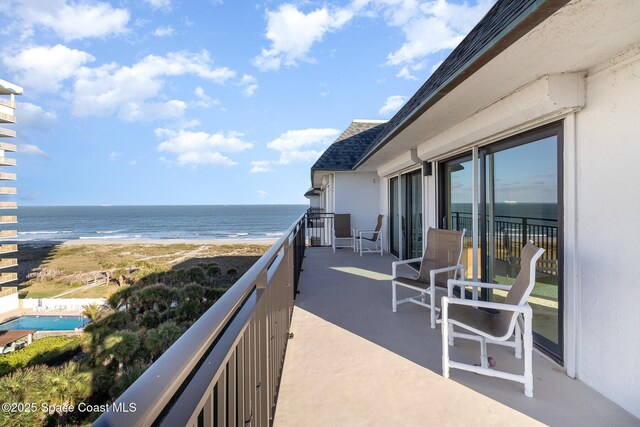 balcony with a view of the beach and a water view