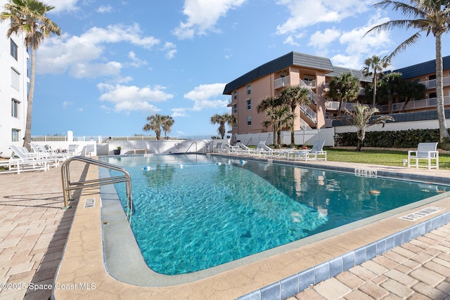 pool with fence and a patio