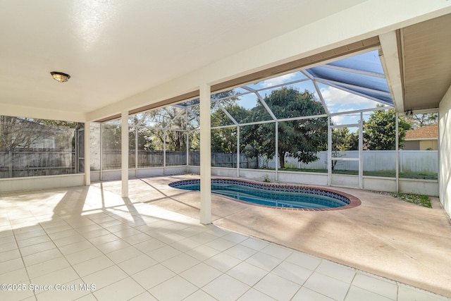 view of swimming pool with glass enclosure and a patio area