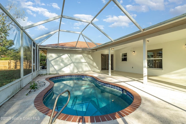 view of swimming pool featuring a lanai and a patio area