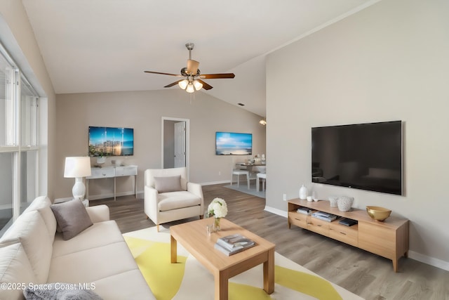 living room featuring hardwood / wood-style floors, vaulted ceiling, and ceiling fan