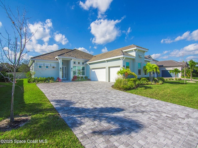 view of front of property featuring a garage and a front yard