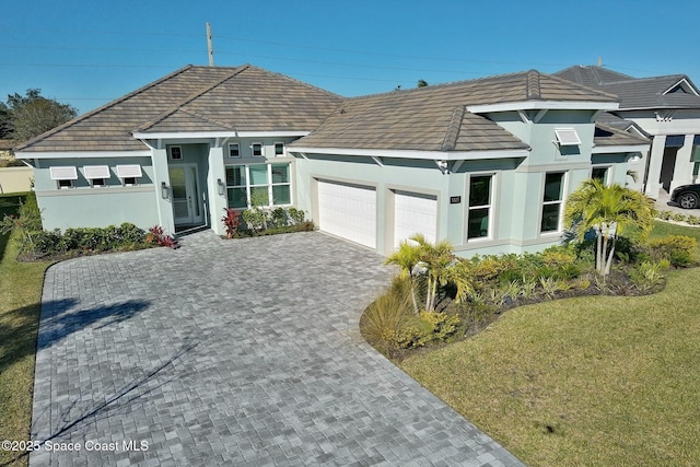 view of front of property with a front lawn and a garage