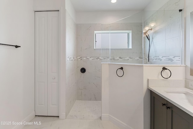 bathroom with vanity and tiled shower