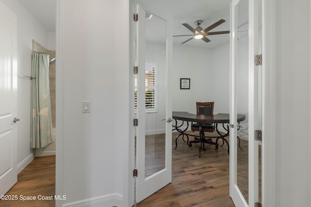 corridor featuring dark wood-type flooring and french doors