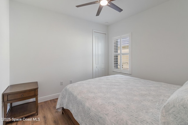 bedroom featuring ceiling fan, wood-type flooring, and a closet