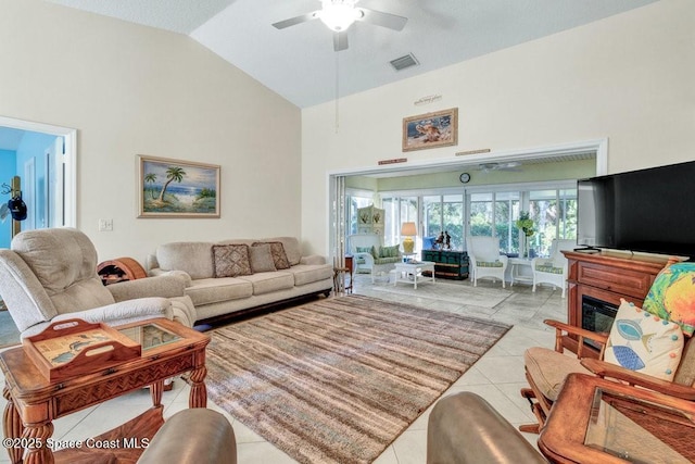 living room featuring light tile patterned floors, ceiling fan, and lofted ceiling