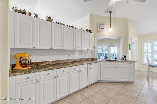 kitchen featuring white dishwasher, vaulted ceiling, ceiling fan, sink, and white cabinetry