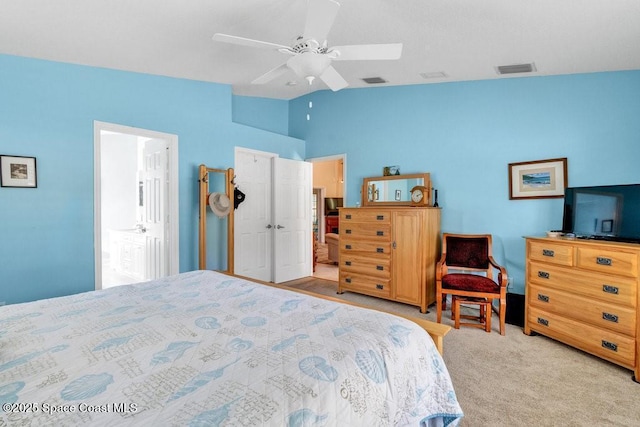 carpeted bedroom with ceiling fan and vaulted ceiling