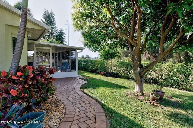 view of yard featuring a sunroom