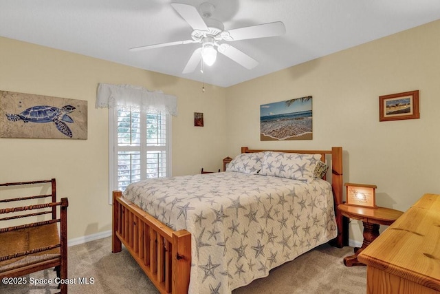 bedroom featuring ceiling fan and light carpet