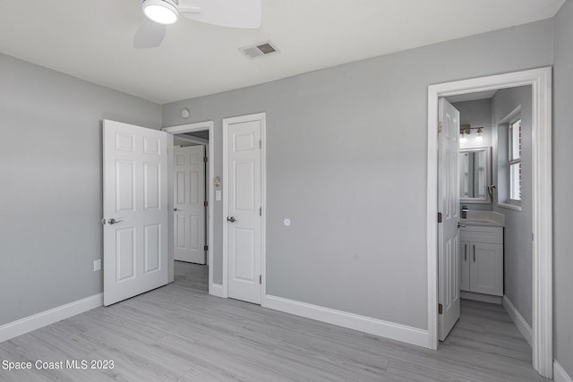 unfurnished bedroom with connected bathroom, light hardwood / wood-style floors, and ceiling fan