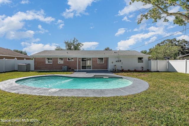 view of pool with central AC unit, a yard, and a patio