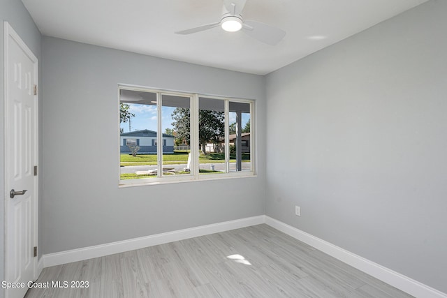 empty room with ceiling fan and light hardwood / wood-style floors