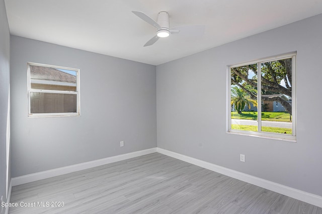 spare room featuring ceiling fan and light hardwood / wood-style flooring