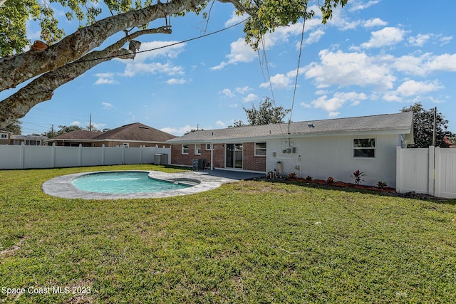 view of pool featuring a yard and a patio