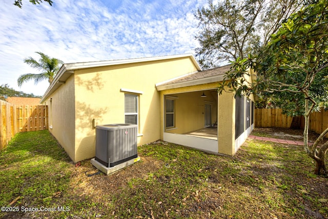 back of house featuring central AC and a sunroom