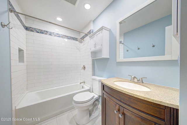 full bathroom with tile patterned flooring, vanity, toilet, and tiled shower / bath