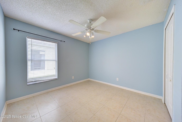 unfurnished room featuring light tile patterned floors, a textured ceiling, and ceiling fan