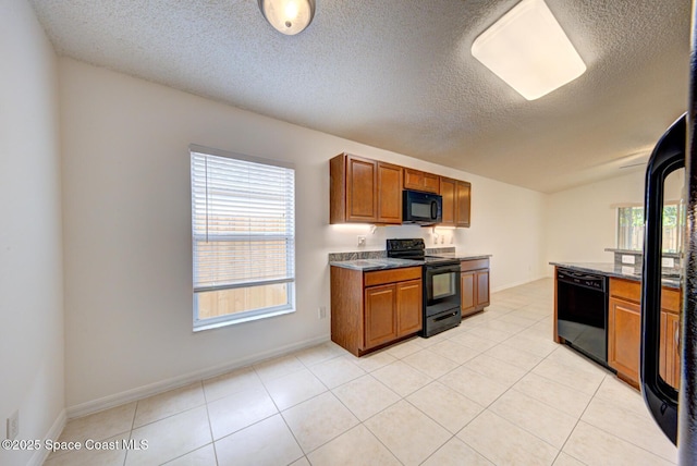 kitchen featuring light tile patterned floors, a textured ceiling, lofted ceiling, and black appliances