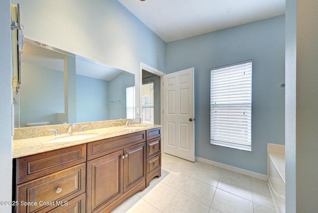 bathroom with tile patterned floors, vanity, toilet, and a washtub