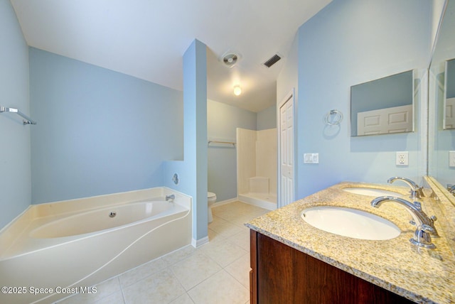 bathroom featuring a washtub, tile patterned floors, vanity, and toilet