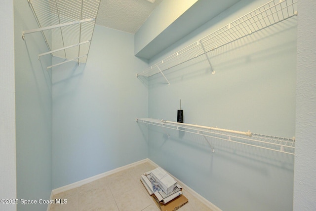 walk in closet featuring tile patterned flooring