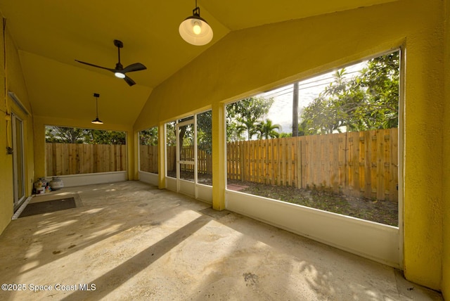 unfurnished sunroom with ceiling fan and lofted ceiling