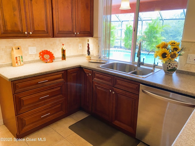 kitchen with dishwasher, decorative backsplash, and sink