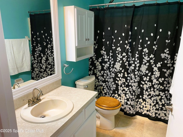 bathroom with toilet, vanity, tile patterned floors, and a shower with shower curtain