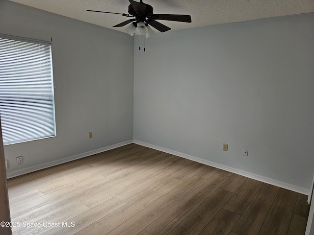 unfurnished room featuring ceiling fan, a textured ceiling, and light hardwood / wood-style flooring