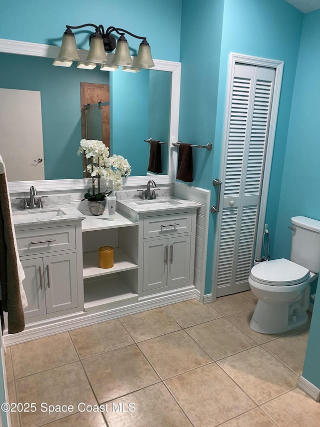 bathroom featuring toilet, vanity, and tile patterned floors