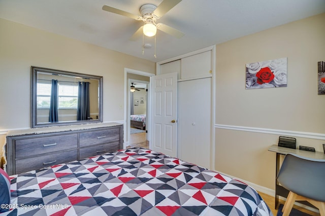 bedroom featuring dark hardwood / wood-style flooring, ceiling fan, and a closet