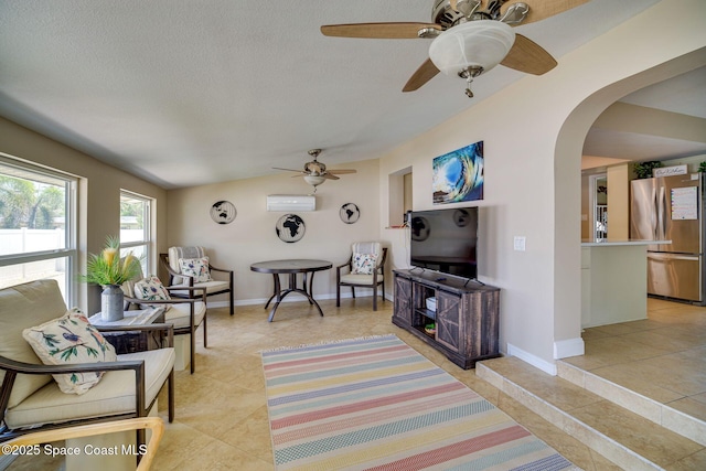 tiled living room featuring an AC wall unit and vaulted ceiling