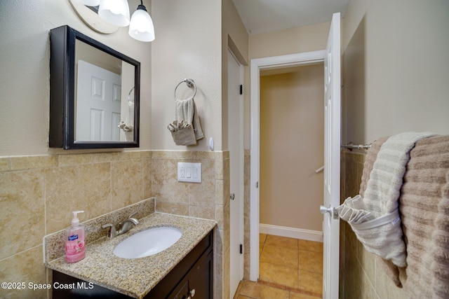 bathroom featuring tile patterned flooring, vanity, and tile walls